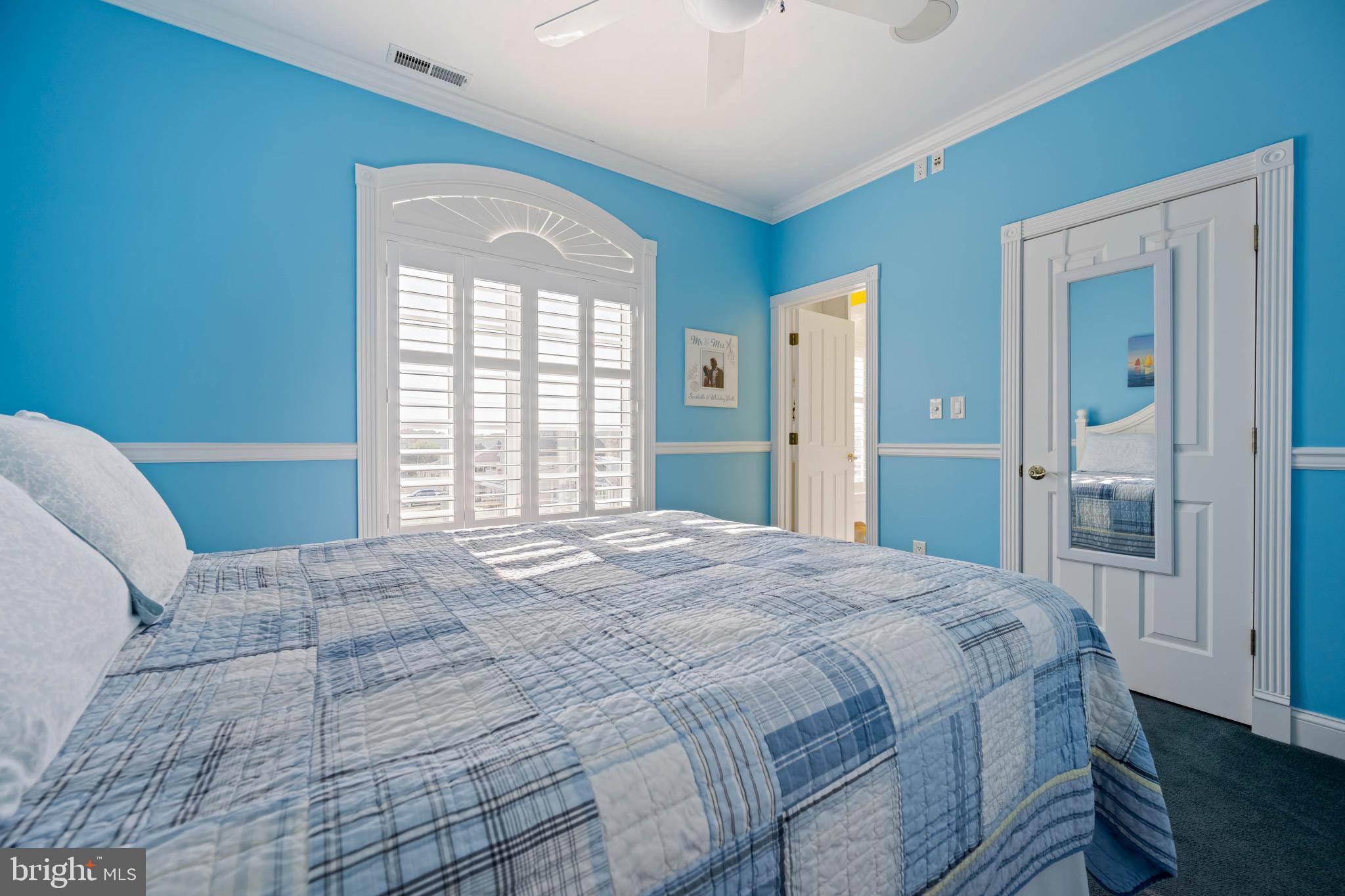 12959 Harbor Road Ocean City, MD 21842 - Photo 33 of 85 a bedroom with a large bed and a window