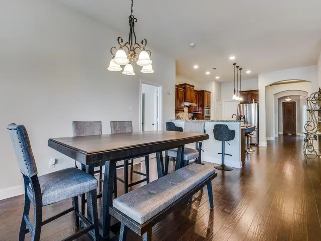 a view of a dining room with furniture wooden floor and chandelier