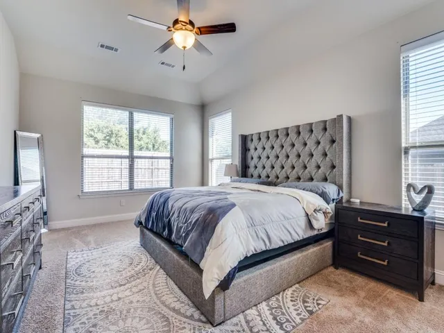a bedroom with a bed and a chandelier
