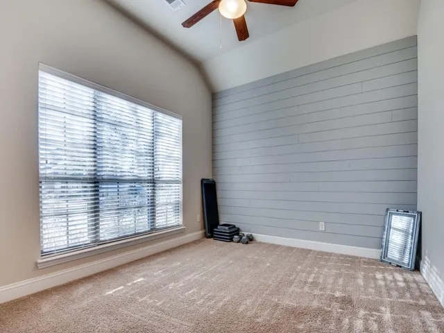 a view of a livingroom with a ceiling fan and window