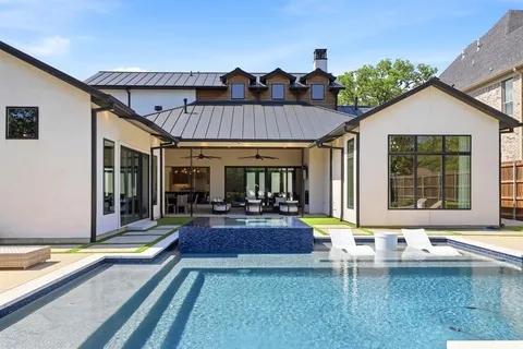 a view of a house with swimming pool and sitting area