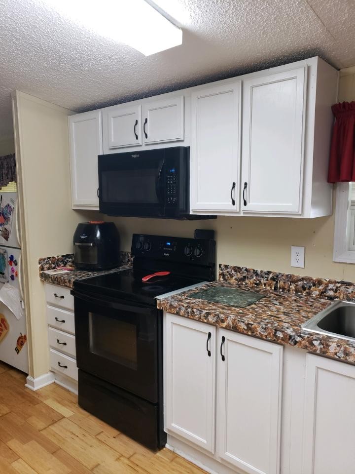 1354 Holloway Road Lebanon, TN 37090 - Photo 6 of 9 a kitchen with stainless steel appliances granite countertop a stove a microwave and cabinets