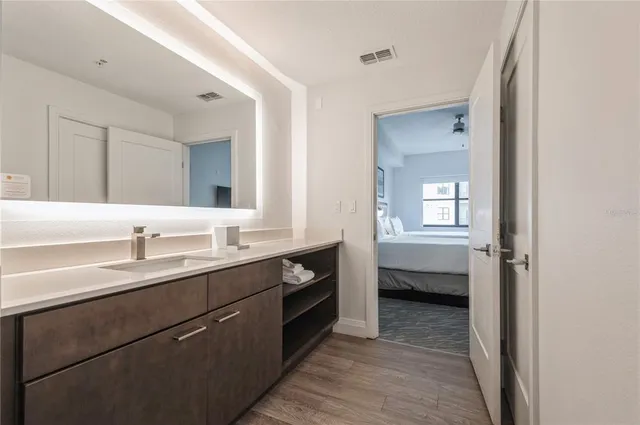 a en suite bathroom with a double vanity sink a mirror and a