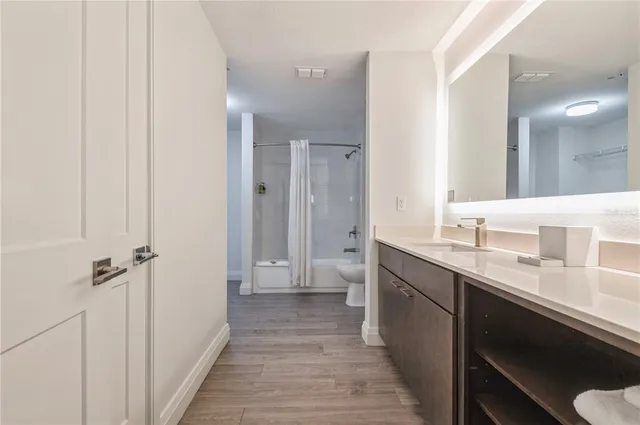 a bathroom with a double vanity sink and mirror