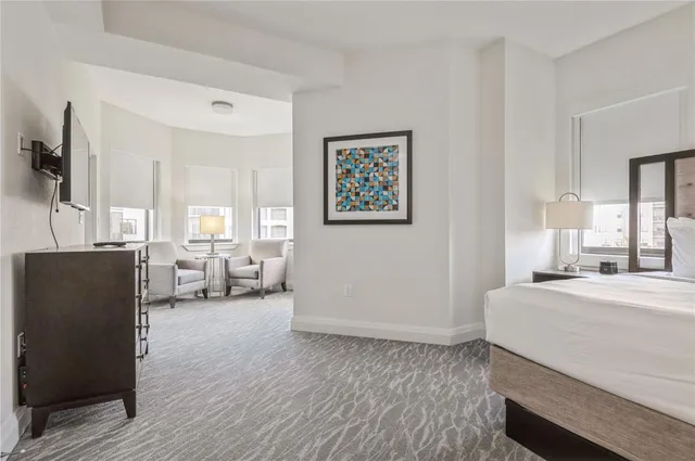 a bedroom with a bed and a couch