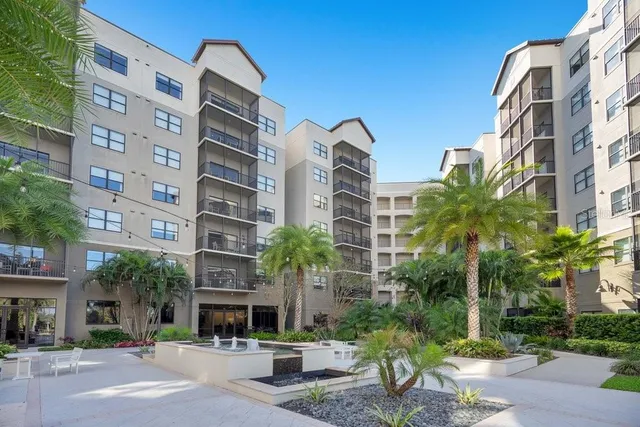 a view of a building with garden and sitting area