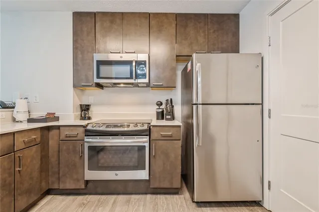 a kitchen with a stove microwave and refrigerator