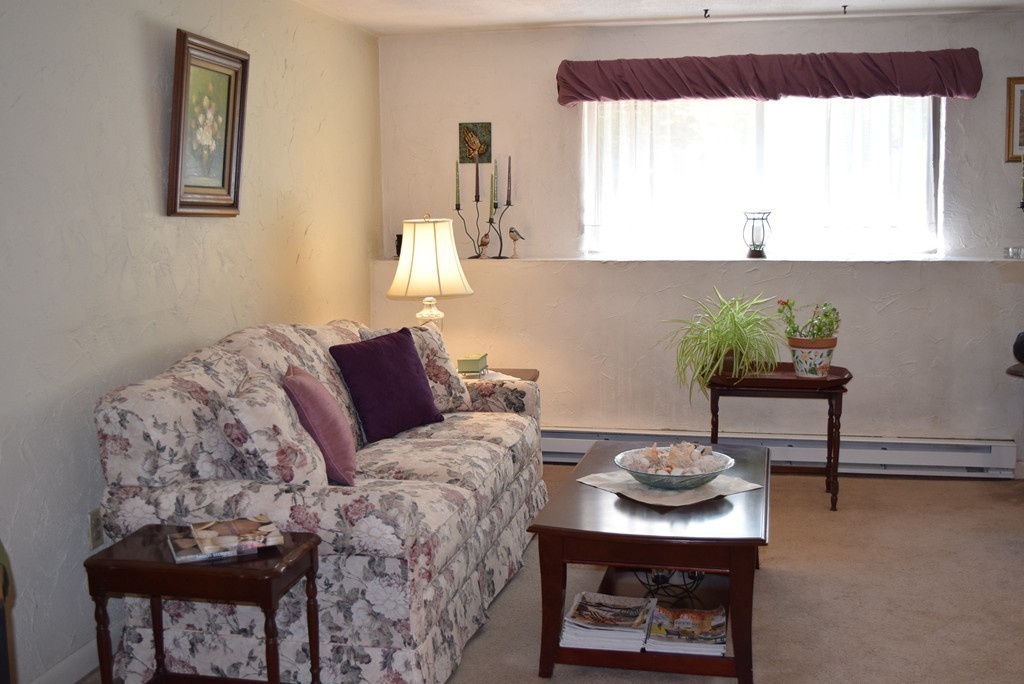 140 Swanson Road, Unit 413 Boxborough, MA 01719 - Photo 2 of 26 a living room with furniture and a potted plant
