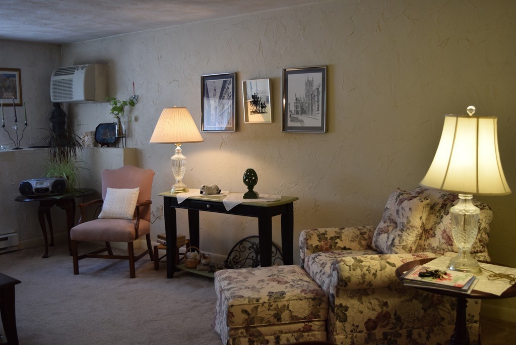 140 Swanson Road, Unit 413 Boxborough, MA 01719 - Photo 3 of 26 a living room with furniture and a lamp