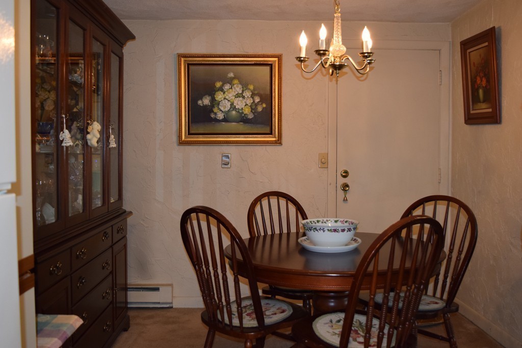 140 Swanson Road, Unit 413 Boxborough, MA 01719 - Photo 5 of 26 a view of a dining room with furniture and chandelier