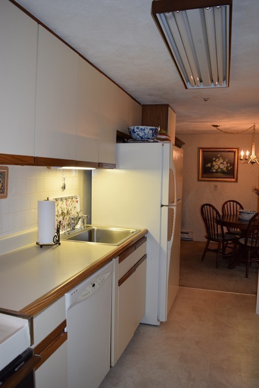 140 Swanson Road, Unit 413 Boxborough, MA 01719 - Photo 10 of 26 a kitchen with stainless steel appliances granite countertop a sink refrigerator and cabinets