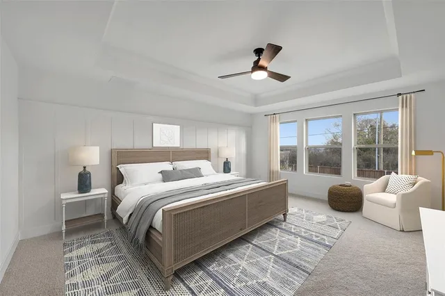 a bedroom with a large bed and windows