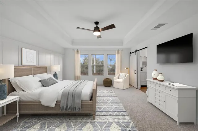 a bedroom with a large bed and a flat screen tv