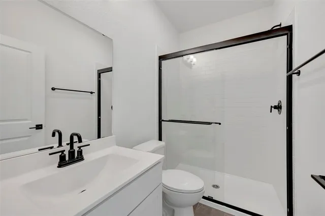 a bathroom with a sink toilet and shower