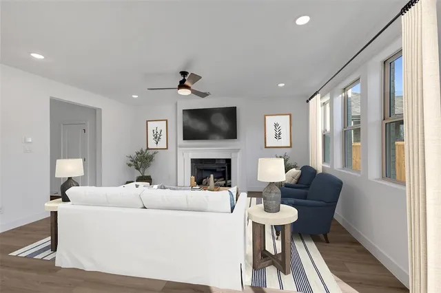 a living room with furniture a fireplace and a flat screen tv