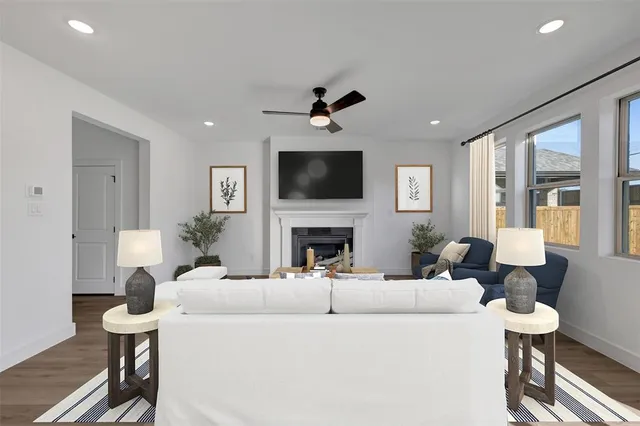 a living room with furniture a fireplace and a flat screen tv