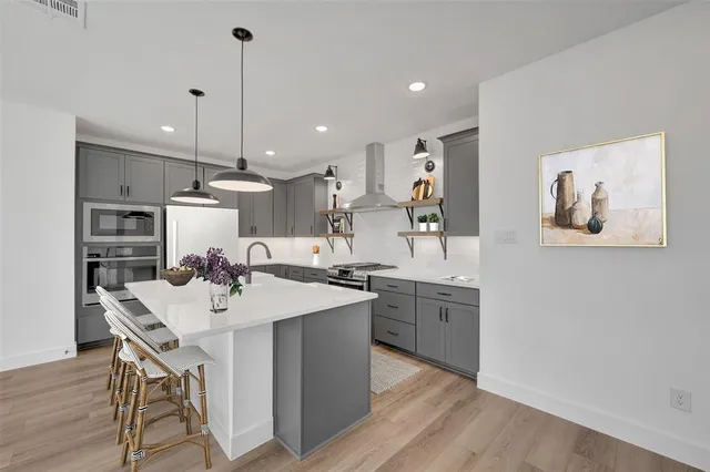 a kitchen with sink cabinets and wooden floor