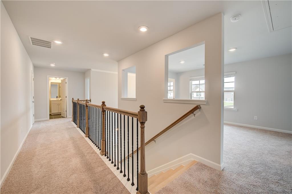 709 Dunlake Way Locust Grove, GA 30248 - Photo 17 of 34 wooden floor with windows and stairs