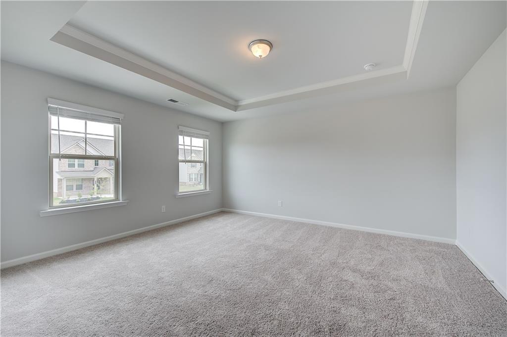 709 Dunlake Way Locust Grove, GA 30248 - Photo 19 of 34 an empty room with windows and closet area