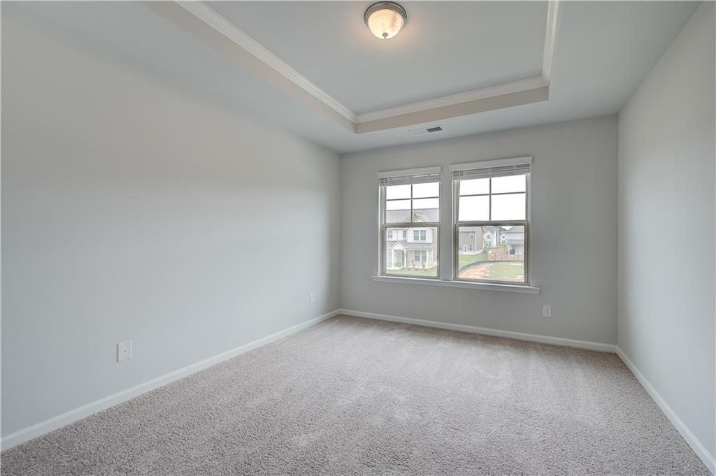 709 Dunlake Way Locust Grove, GA 30248 - Photo 22 of 34 an empty room with a window
