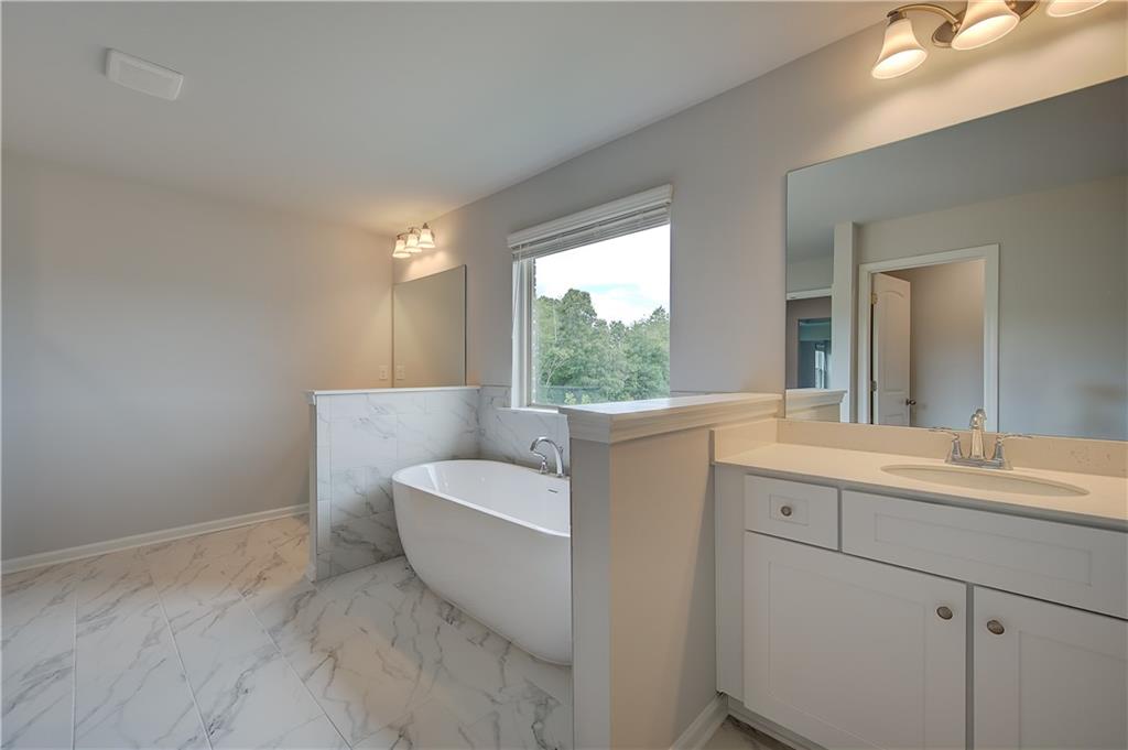 709 Dunlake Way Locust Grove, GA 30248 - Photo 30 of 34 a bathroom with a sink and a mirror