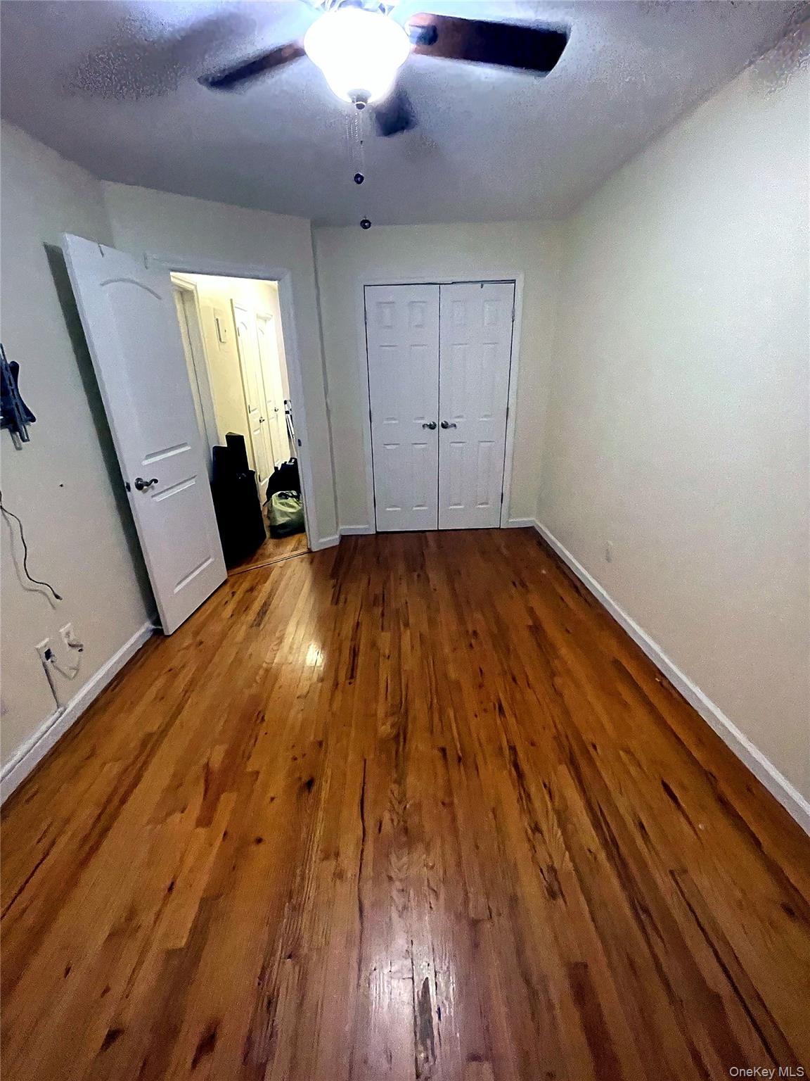 20-23 Whitestone Expressway Queens, NY 11357 - Photo 13 of 28 wooden floor in an empty room with a window