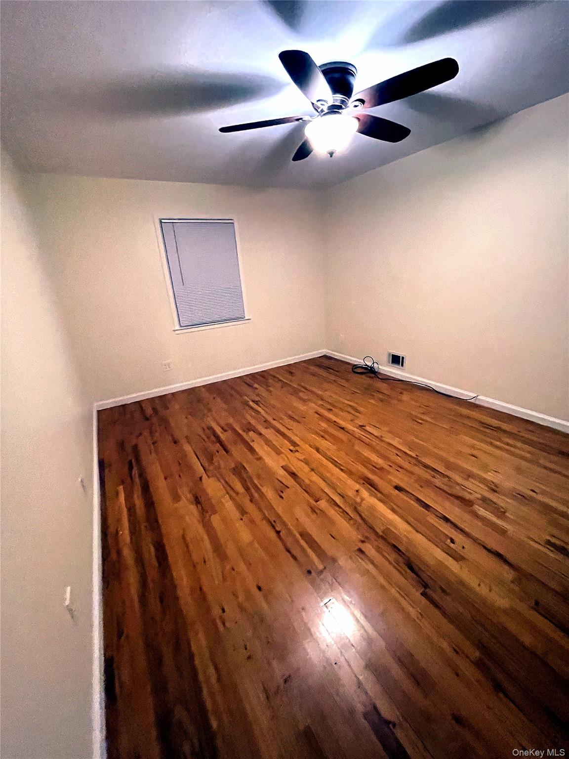 20-23 Whitestone Expressway Queens, NY 11357 - Photo 14 of 28 an empty room with chandelier fan and windows