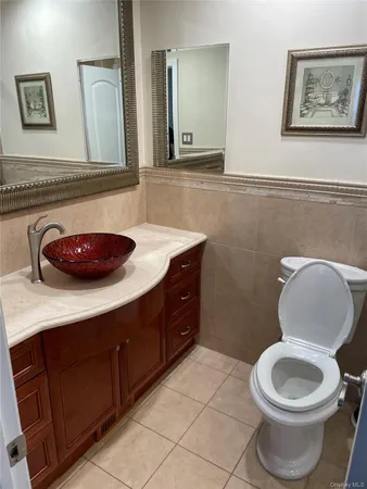 a bathroom with a toilet a sink and a mirror
