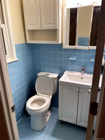 a white toilet sitting next to a sink