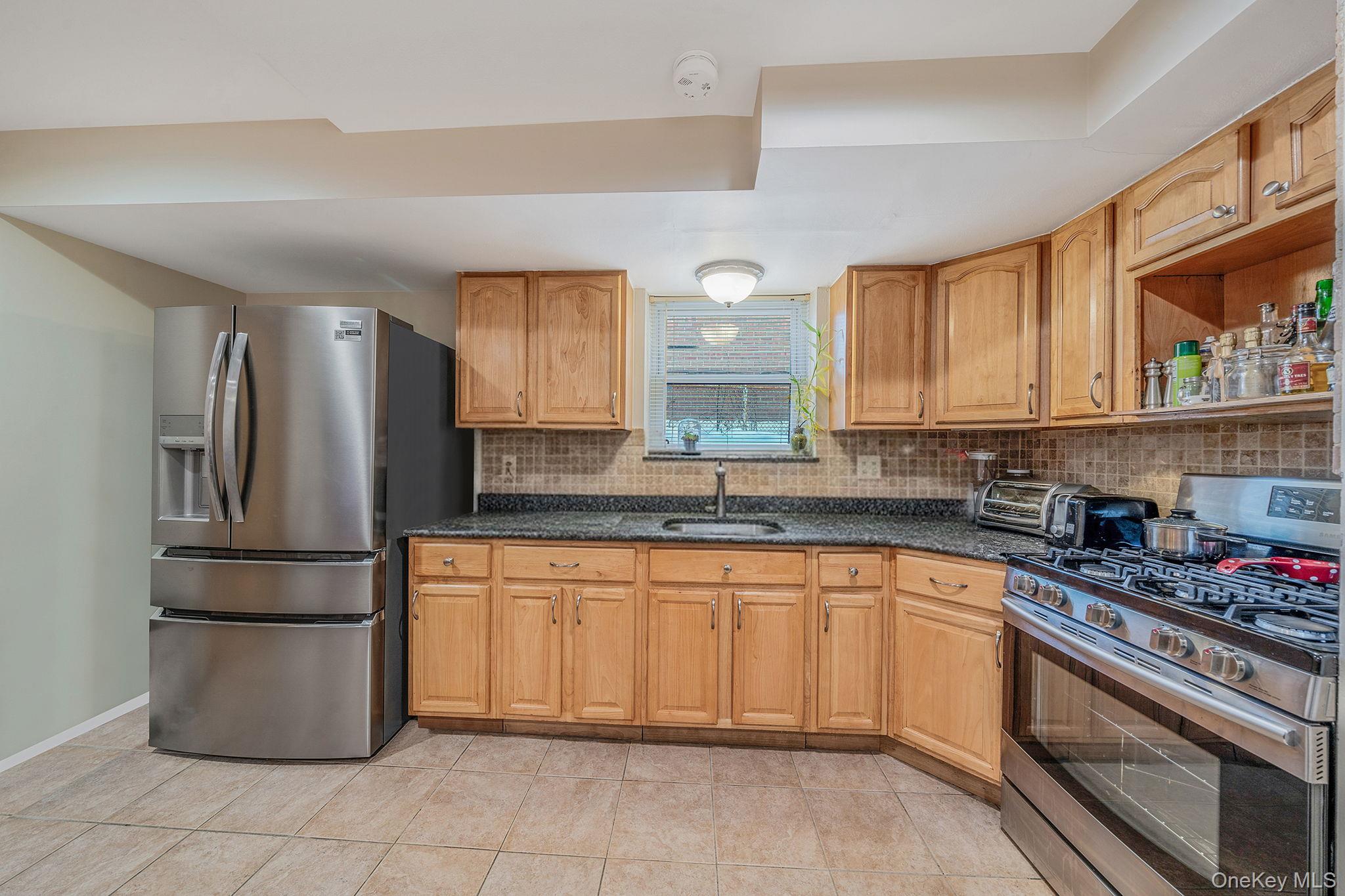 20-23 Whitestone Expressway Queens, NY 11357 - Photo 21 of 28 a kitchen with a refrigerator sink and cabinets