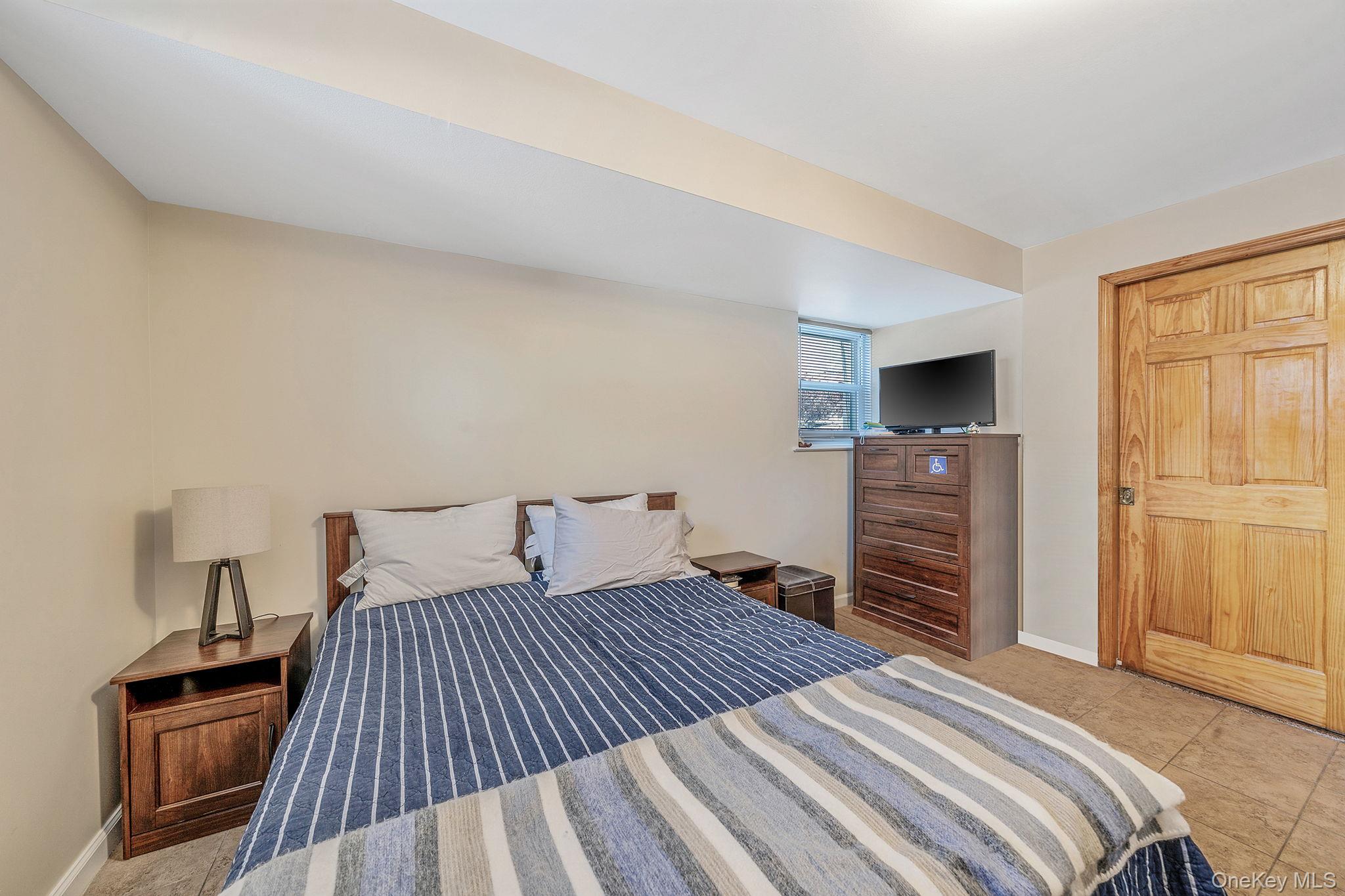 20-23 Whitestone Expressway Queens, NY 11357 - Photo 23 of 28 a bedroom with a bed and a television