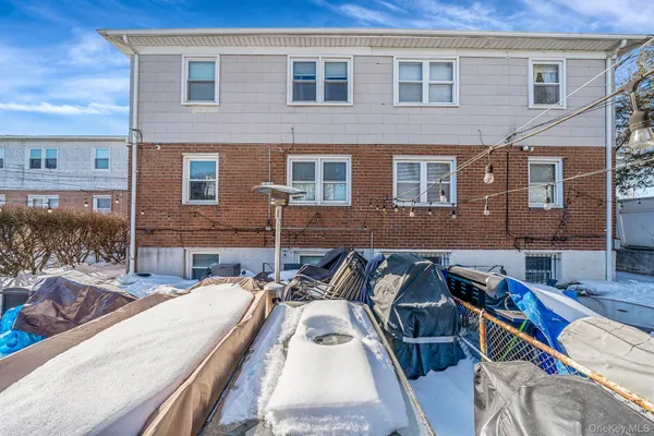 a view of a patio with couches chairs and wooden floor