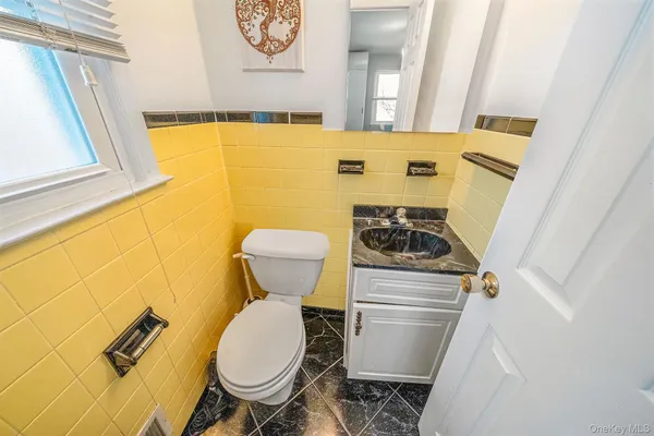 a bathroom with a toilet and a mirror