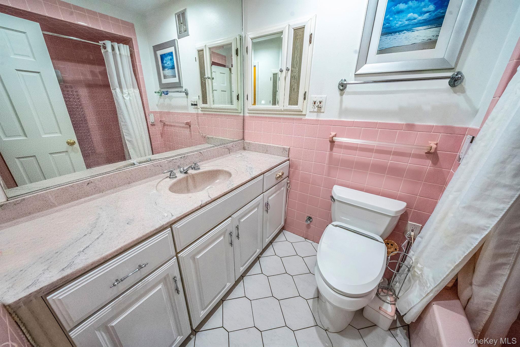 20-23 Whitestone Expressway Queens, NY 11357 - Photo 10 of 28 a bathroom with a sink a toilet and a mirror