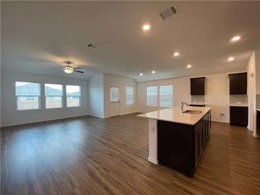 a view of kitchen with sink and wooden floor