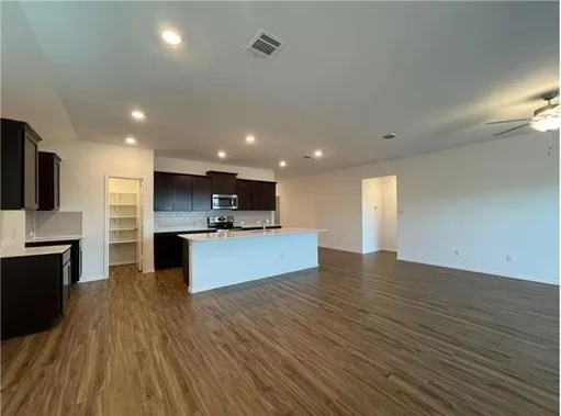a view of a backyard with wooden fence