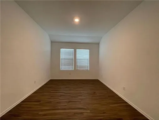 a view of kitchen with cabinets microwave and stove