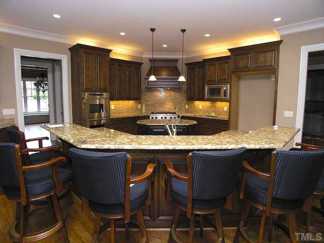 11320 Moonsprite Way Raleigh, NC 27614 - Photo 7 of 12 Center most in this home is the gourmet kitchen. Enhanced with state-of the art appliances, custom cabinets, granite counter tops,walk-in pantry, wine bar and island breakfast bar.