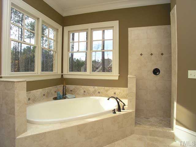 11320 Moonsprite Way Raleigh, NC 27614 - Photo 9 of 12 Plenty of room in this over sized master bath that features a walk in Roman shower and a relaxing whirlpool tub. Double vanities, a private water closet and a incredible large dressing room. The master suite you have been dreaming of.