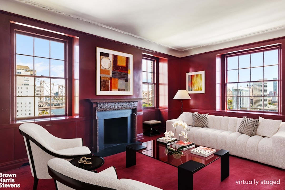 1 Sutton Place South, Unit 11C Manhattan, NY 10022 - Photo 11 of 20 a living room with furniture fireplace and a large window