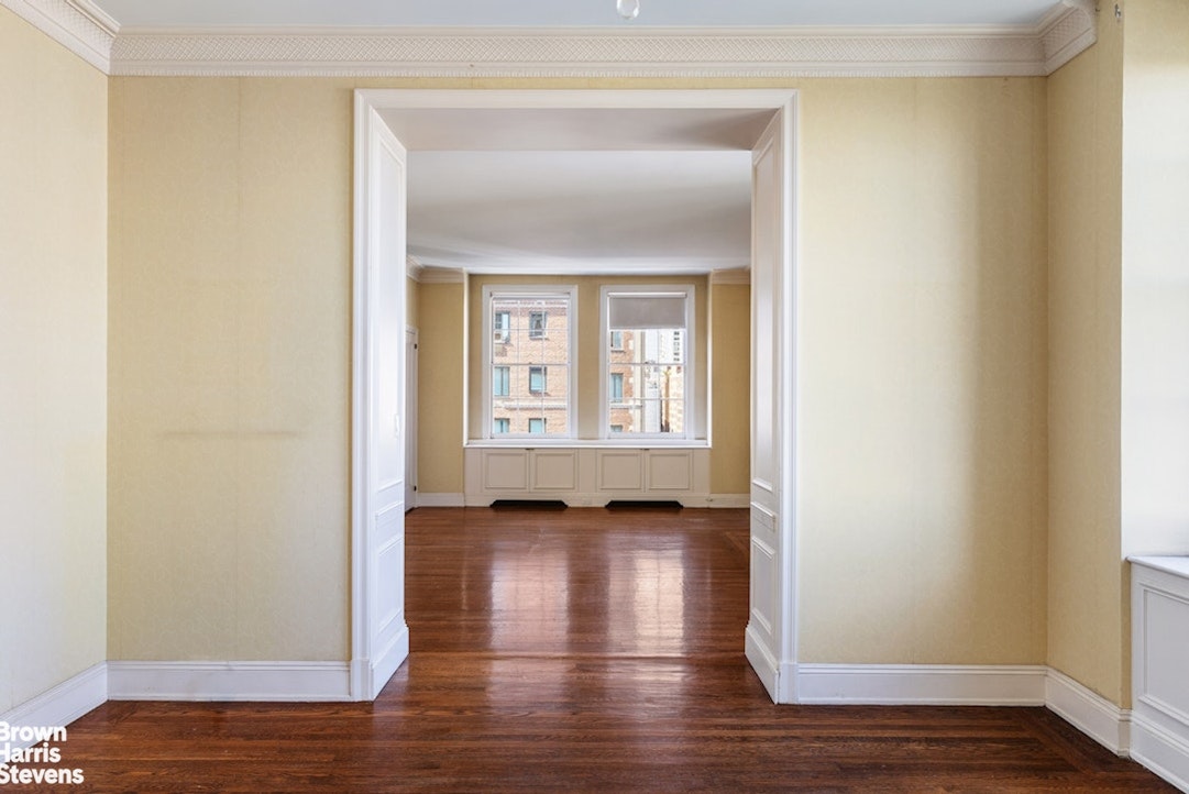 1 Sutton Place South, Unit 11C Manhattan, NY 10022 - Photo 13 of 20 a view of an empty room with wooden floor and a window