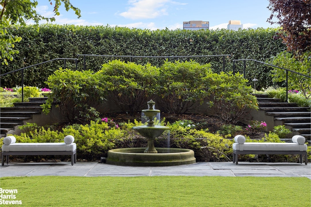 1 Sutton Place South, Unit 11C Manhattan, NY 10022 - Photo 17 of 20 a garden with a bench and some plants