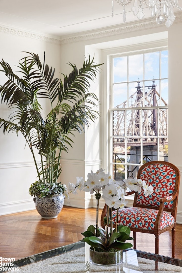 1 Sutton Place South, Unit 11C Manhattan, NY 10022 - Photo 3 of 20 a vase of flowers sitting on a table with window