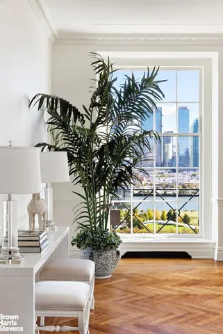 a vase of flowers sitting on a table with window