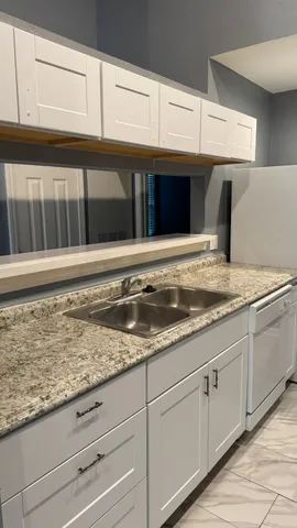 a stove top oven sitting inside of a kitchen