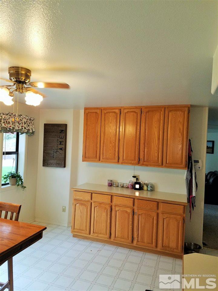 2580 Rice Road Fallon, NV 89406 - Photo 11 of 25 a kitchen with stainless steel appliances granite countertop a refrigerator a sink and wooden cabinets