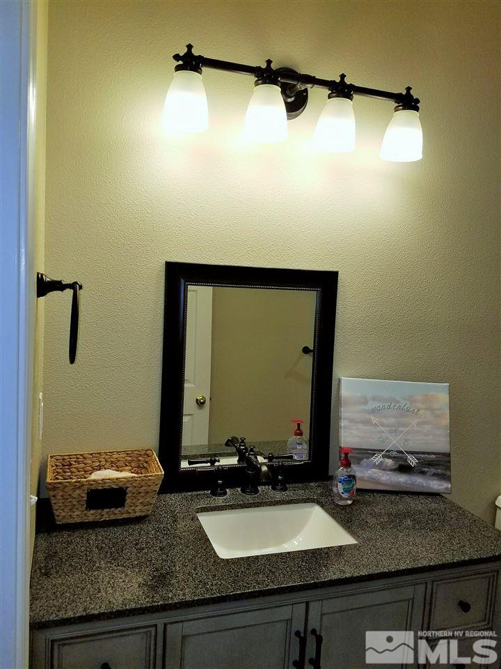 2580 Rice Road Fallon, NV 89406 - Photo 13 of 25 a bathroom with a granite countertop sink and a mirror