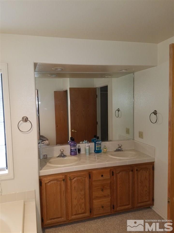 2580 Rice Road Fallon, NV 89406 - Photo 15 of 25 a bathroom with a double vanity sink and a mirror