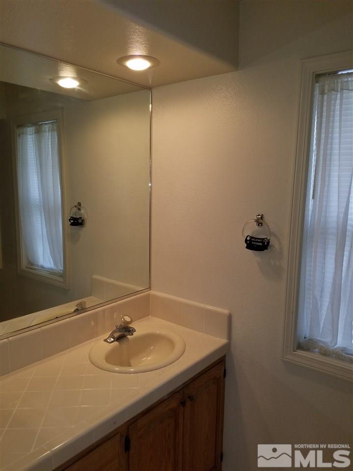 2580 Rice Road Fallon, NV 89406 - Photo 19 of 25 a bathroom with a sink and a mirror