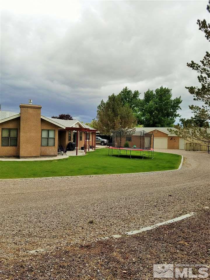 2580 Rice Road Fallon, NV 89406 - Photo 3 of 25 a view of building with a big yard and large trees